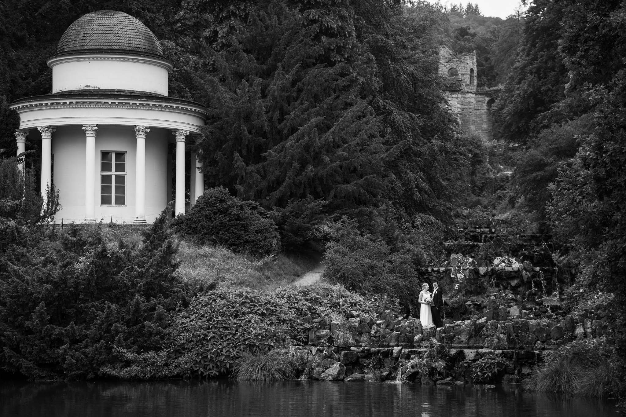 Brautpaar mit Wasserfall und Pavillion im Bergpark Wilhelmshöhe